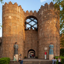 Two children with their mother walking through the Poble Espanyol in Barcelona
