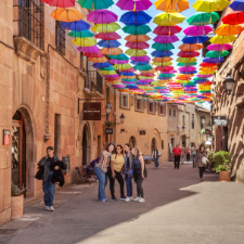 Two children with their mother walking through the Poble Espanyol in Barcelona