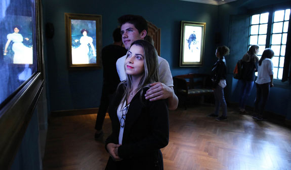 Couple looking at work by Ramon Casas inside the Monastery of Sant Benet